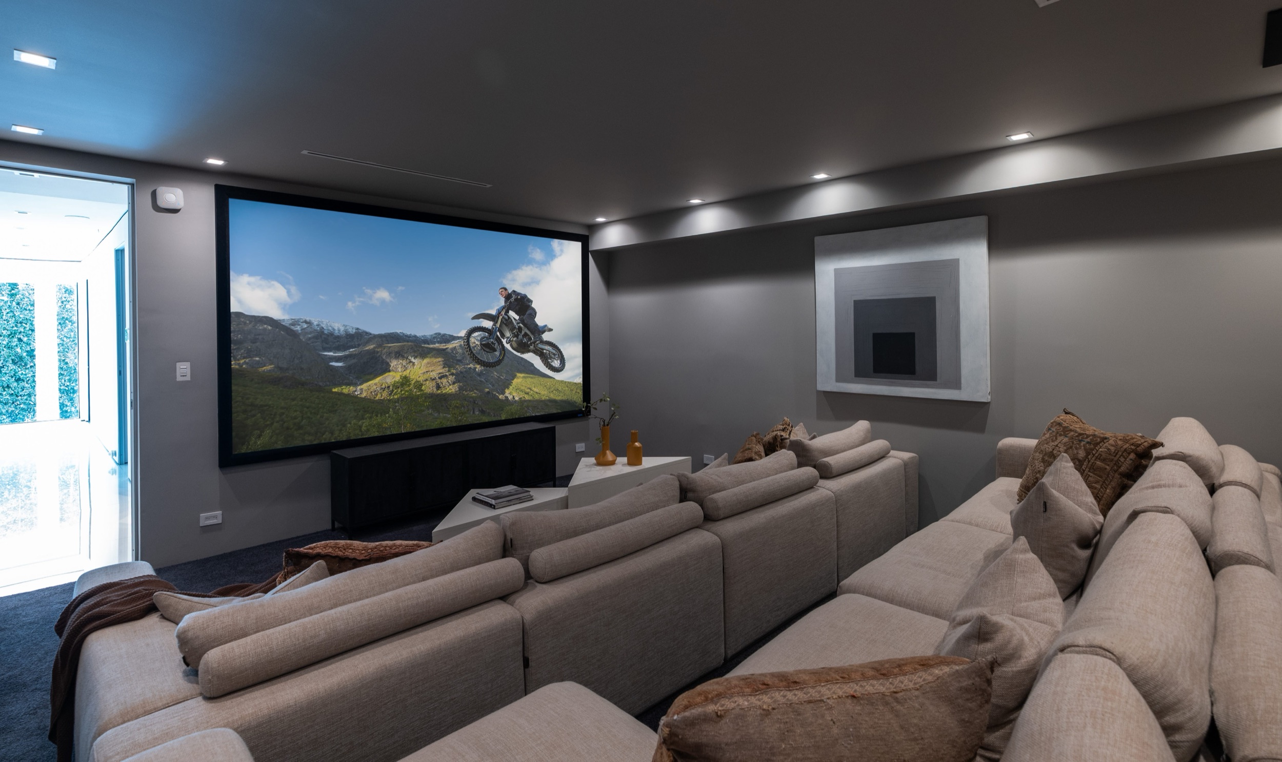 Private theater with tiered seating and 144 inch screen