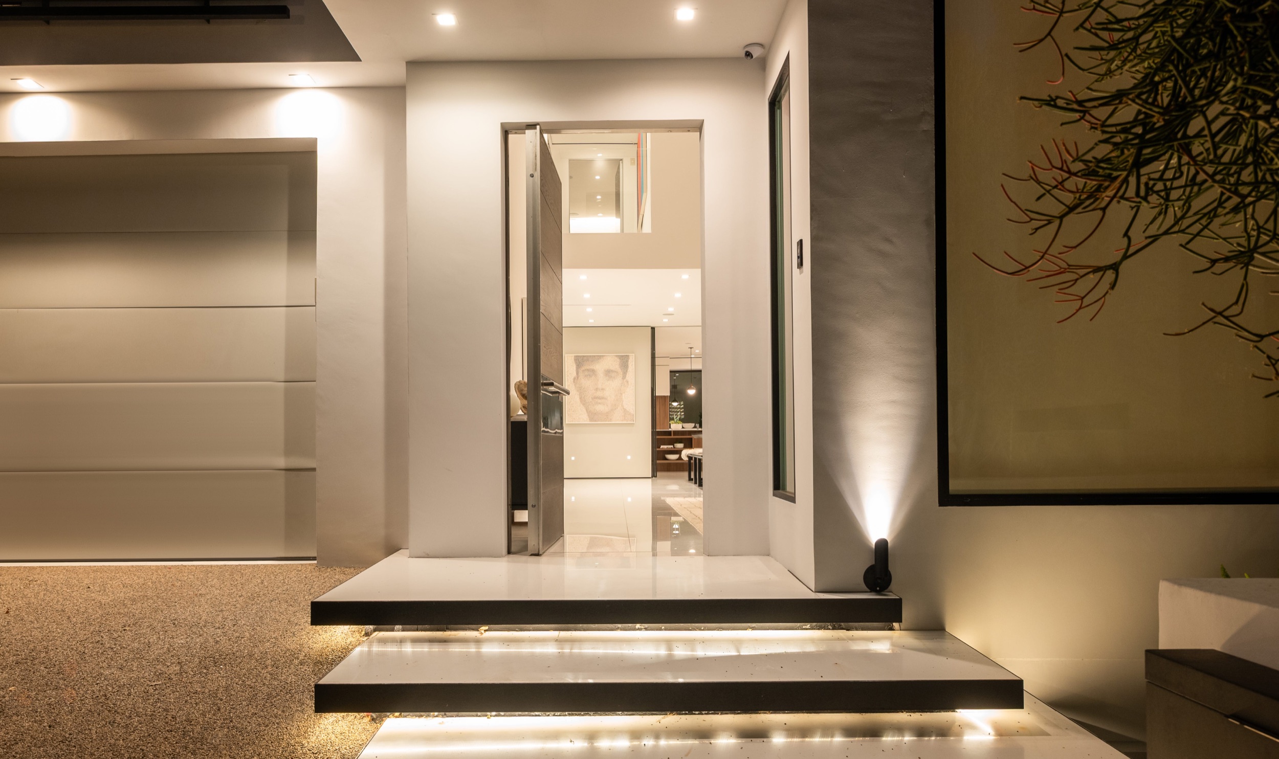 Front door open at night onto the lit living room