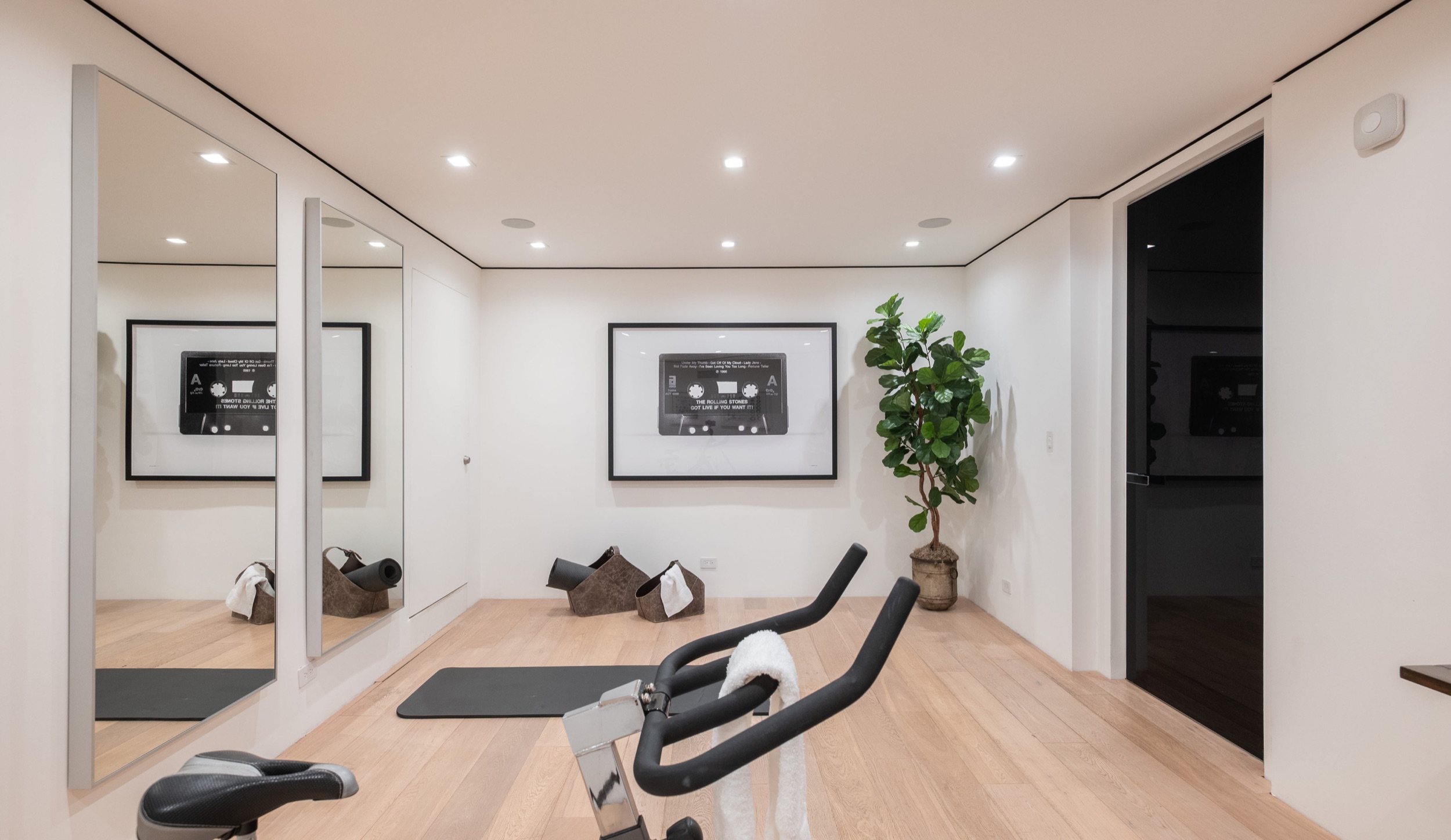 Gym floor with mat and bench under the mounted screen
