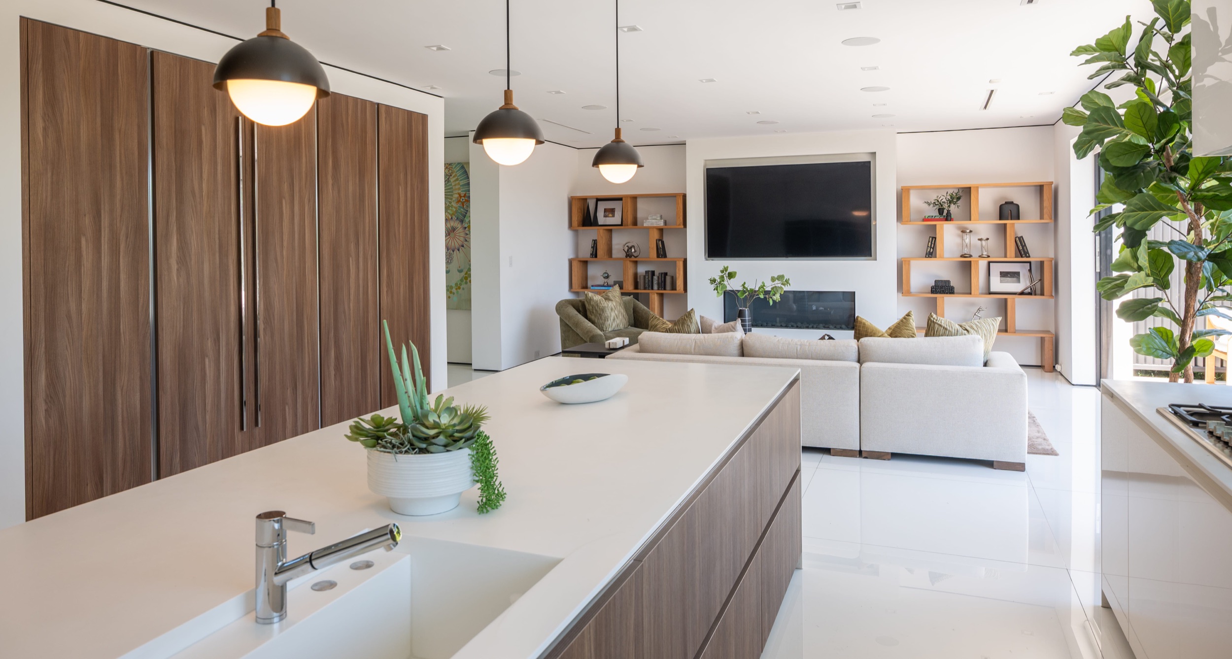 Kitchen from the dining side with the range and full height cabinetry