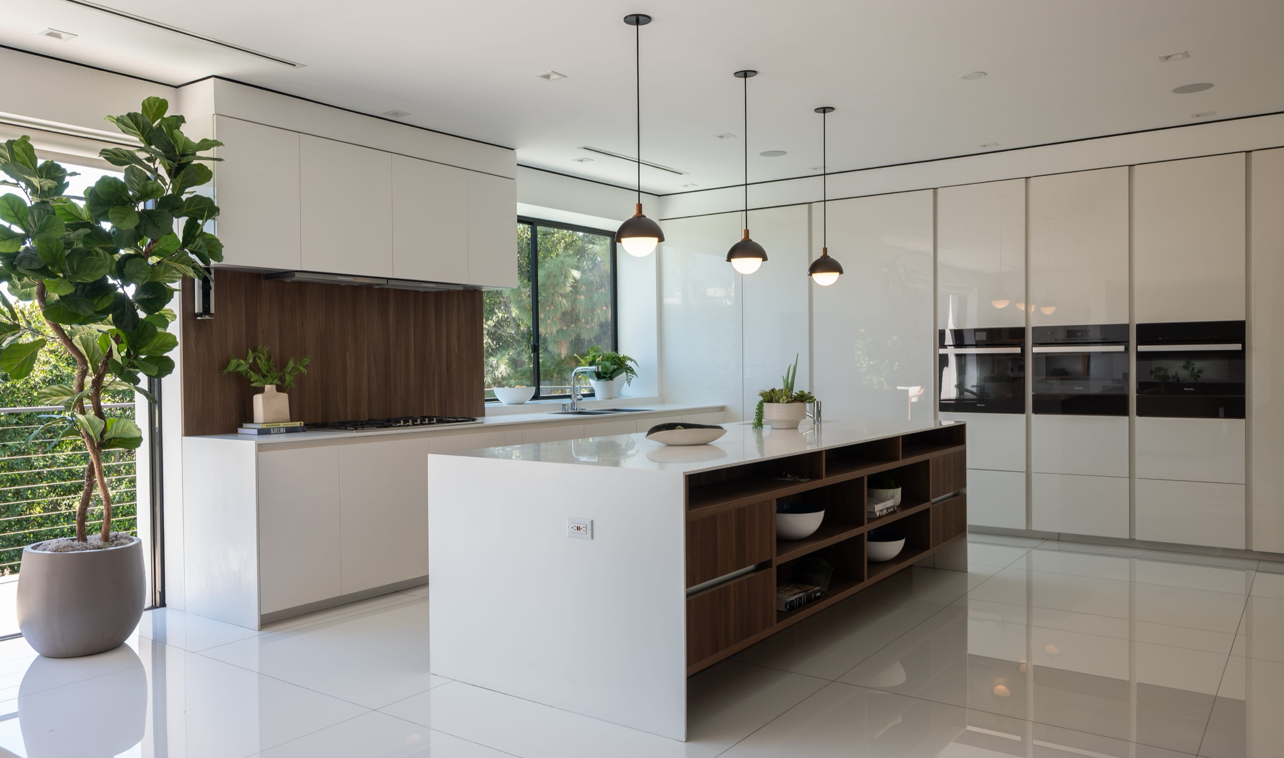 Kitchen with island, quartz surfaces and Miele appliances