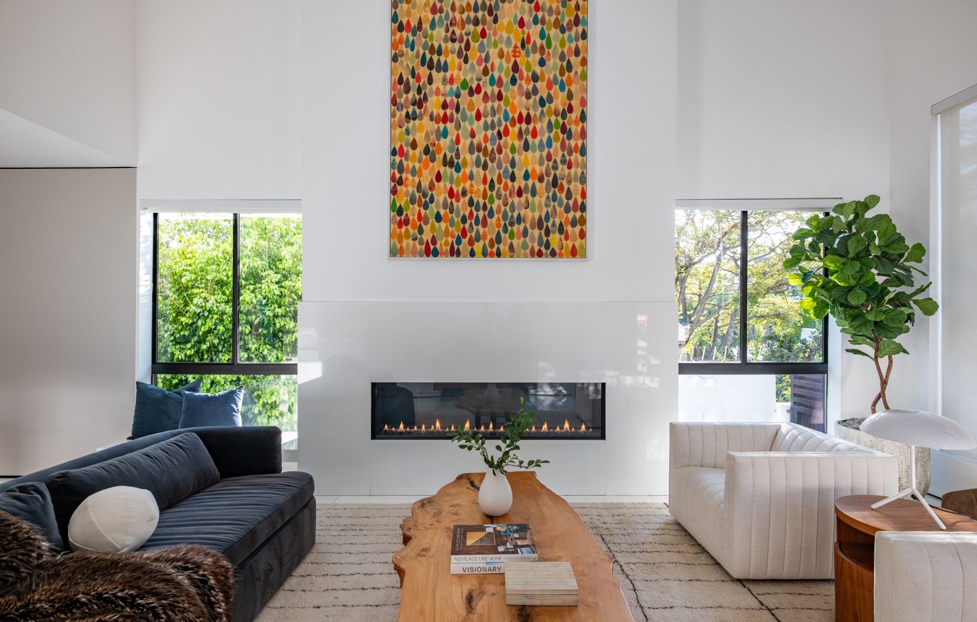 Living room with the linear fireplace between tall windows