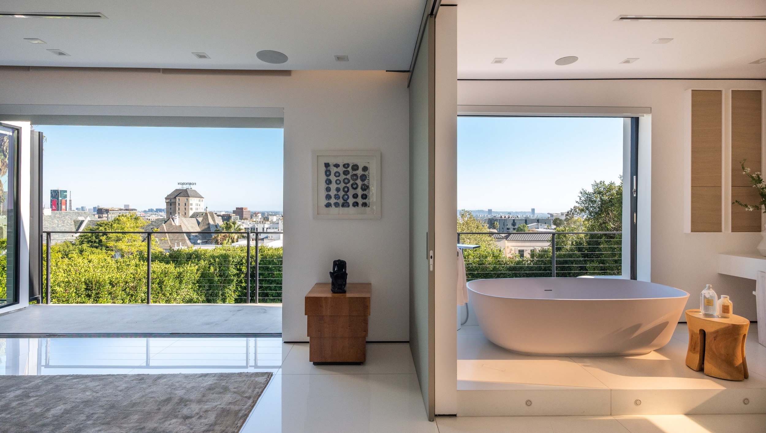 Primary bath from the bedroom side, tub against the city view