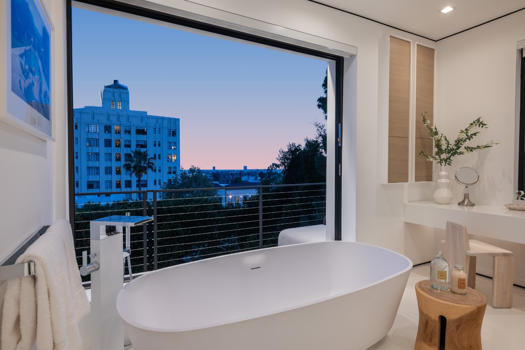 Primary bath at dusk looking out over the city
