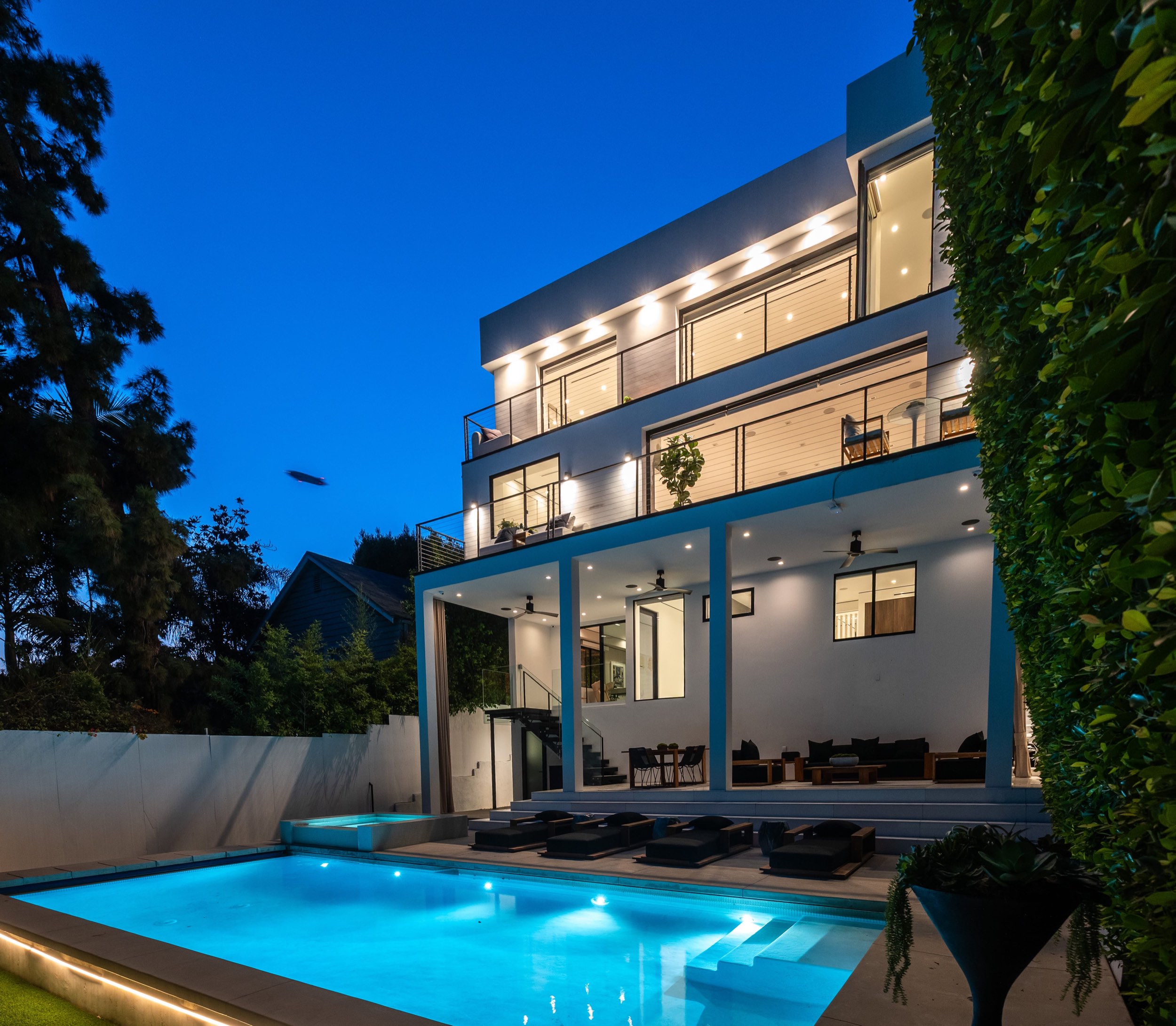 Rear elevation at dusk from the pool deck