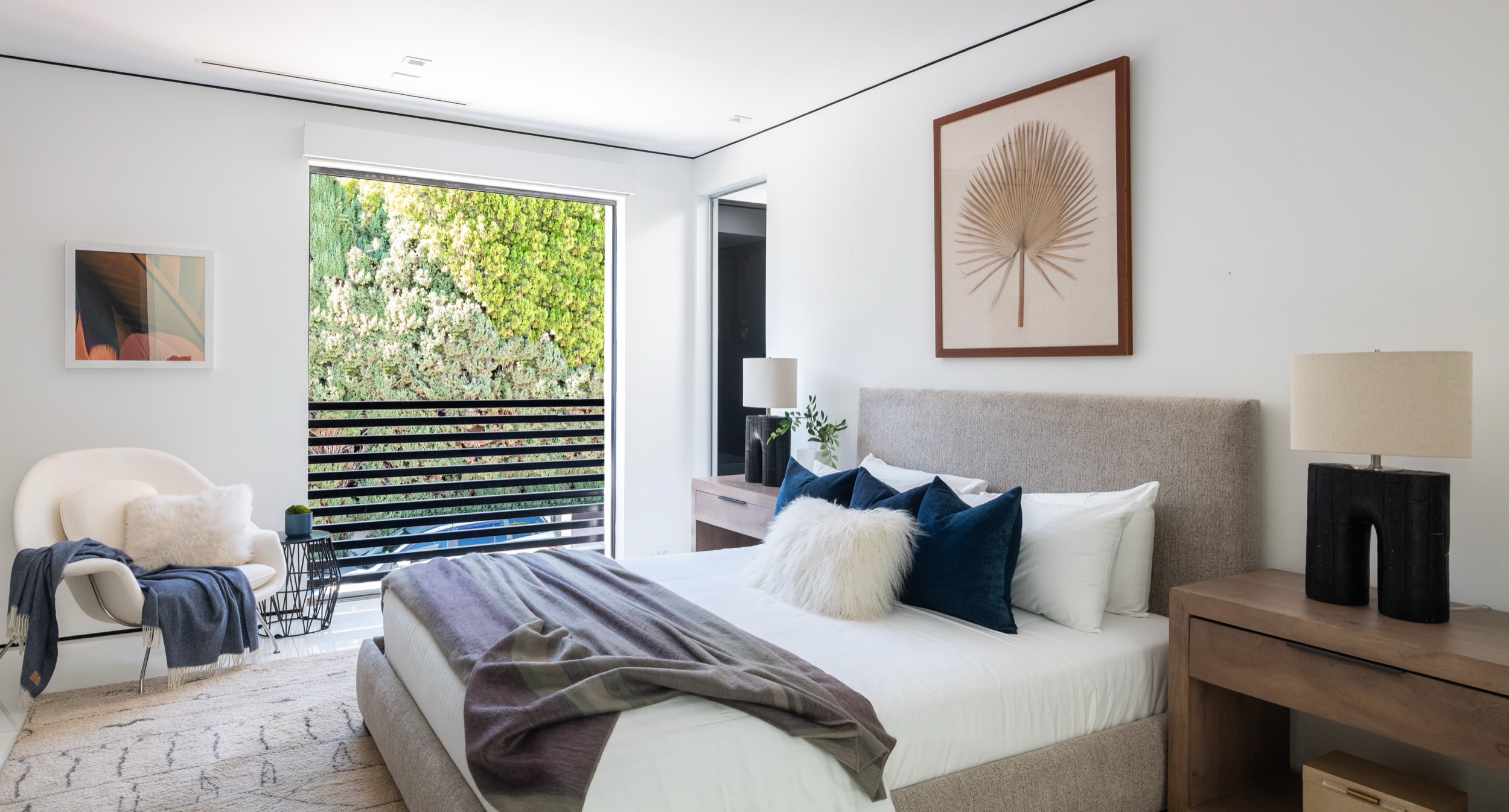 Upstairs guest bedroom 1 with louvred screen, armchair and bench