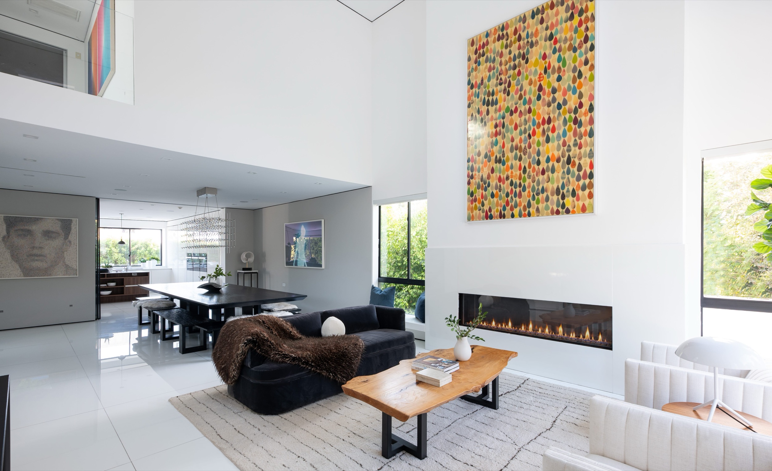 Double height living room with linear fireplace and tall windows