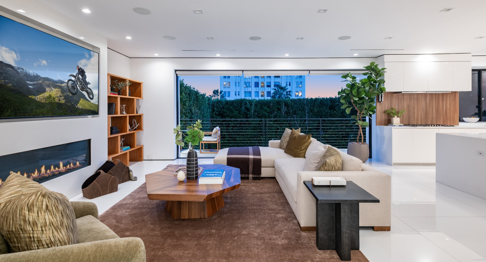 Family room at twilight open to the terrace beyond